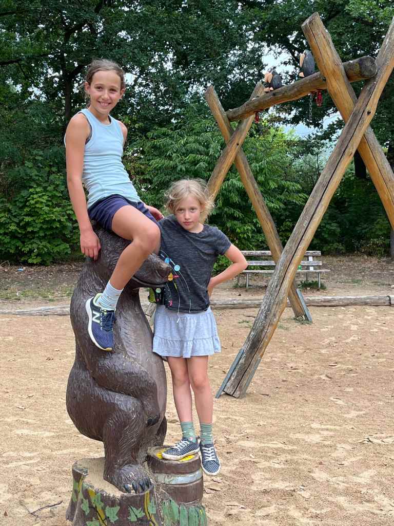 Kids at park atop bear